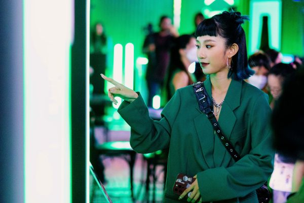 A drinker taps the Ghost Protocol screen at a Heineken bar to invite missed friends and send rides.