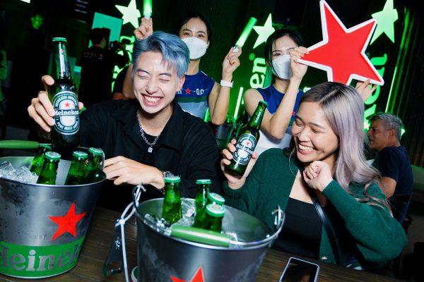Friends reconnecting over refreshing ice-cold Heineken.