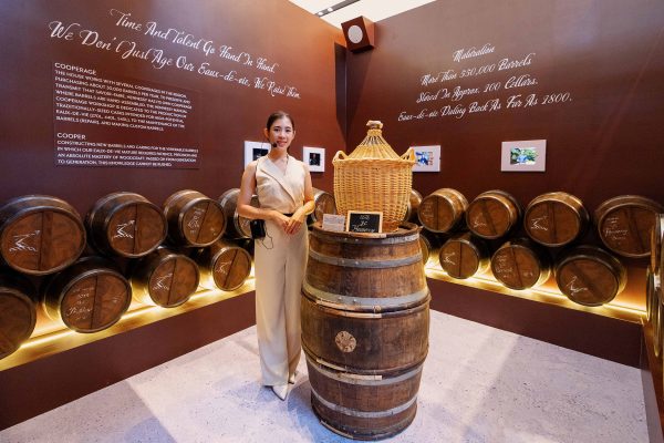 A French oak barrel display introduces the Maison's cellar maturation process.